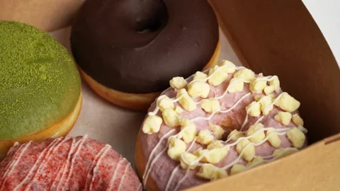 Stack of pink frosted donuts with rainbow sprinkles. donut dessert bakery Stock Footage 294137758