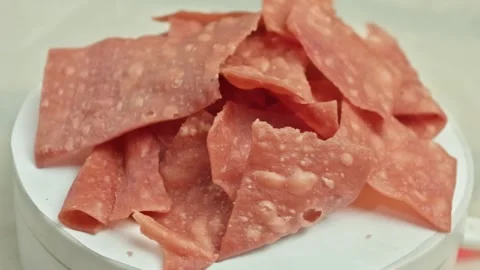 Stack of pink sweet crackers with crunchy texture rotating on a white display Stock Footage 323572039