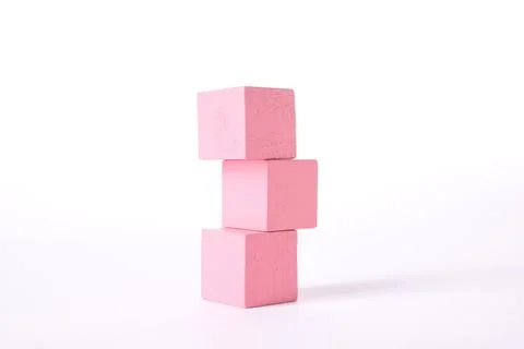 Stack of pink wooden cubes on white background Stockfoto's