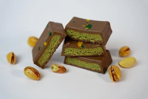Stack of Pistachio Chocolate Bars with Nuts, White Background Stock Photos