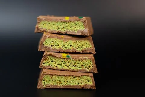 Stack of Pistachio Dubai Chocolate Bars. Elegant Gourmet Treat Stock Photos