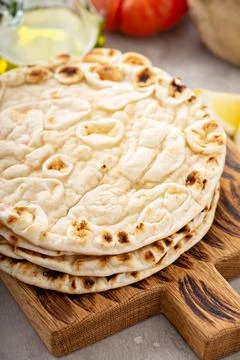 A stack of pita bread on a cutting board Stock Photos