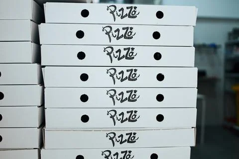 A stack of pizza boxes with the word pizza on them Stock Photos