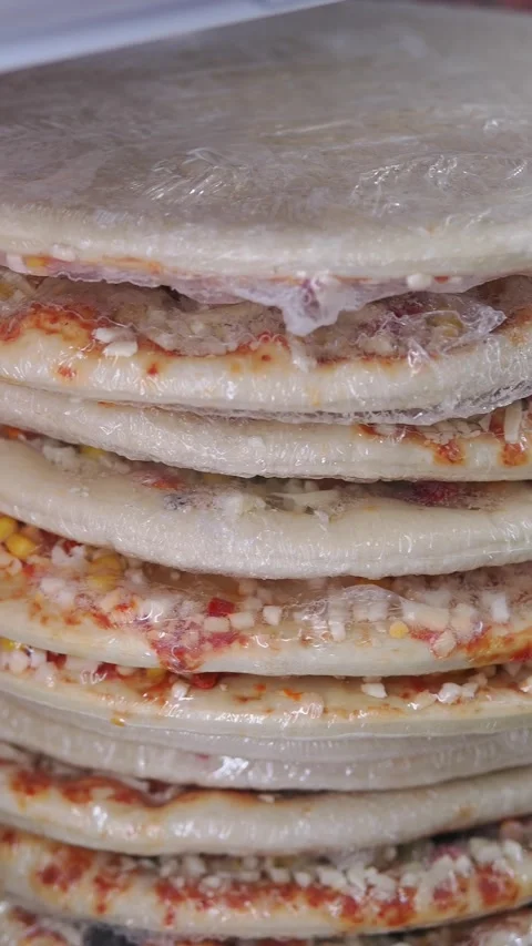 Stack of pizza stored in a fridge Stock Footage 347109492