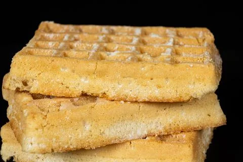 Stack of plain Belgian waffles isolated on black background. Foto stock