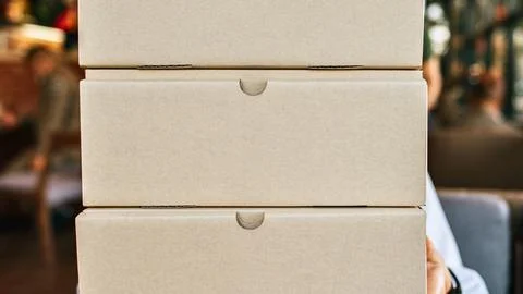 Stack of plain cardboard boxes ready for shipping or storage Stock Photos