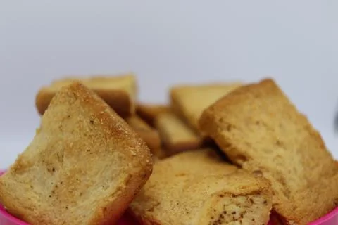 Stack of plain melba toasts on white Background. Edible square dry toast slic Stock Photos