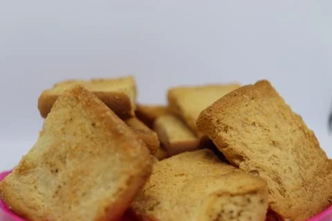 Stack of plain melba toasts on white Background. Edible square dry toast slic Stock Photos