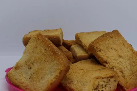 Stack of plain melba toasts on white Background. Edible square dry toast slic Stock Photos