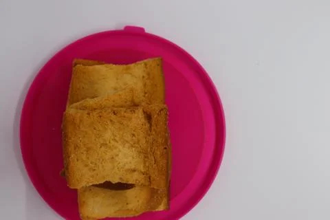 Stack of plain melba toasts on white Background. Edible square dry toast slic Stock Photos