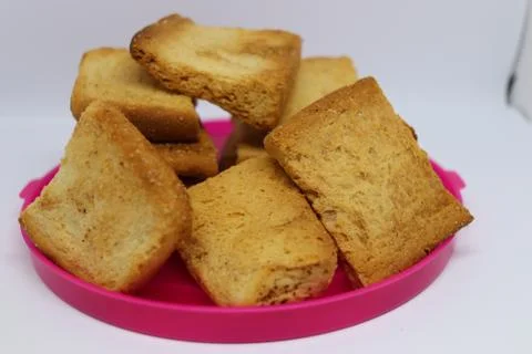 Stack of plain melba toasts on white Background. Edible square dry toast slic Stock Photos