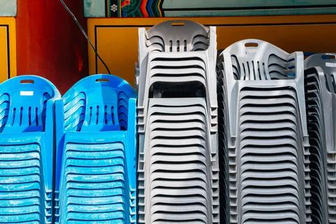 Stack of plastic chairs Fotos Stock