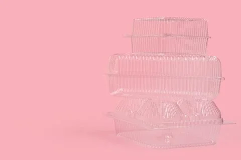 Stack of plastic containers for food on pink background Fotos de archivo