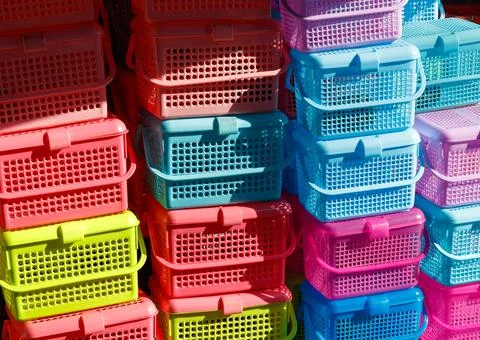 A stack of plastic containers in various colors 스톡 사진