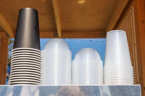 A stack of plastic cups on a metal shelf Stock Photos