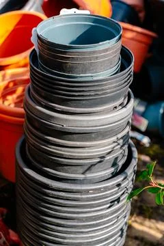 Stack of Plastic Plant Pots in Garden Scene Fotos de archivo