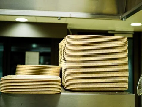 Stack of plastic serving trays arranged in a professional kitchen interior Foto stock