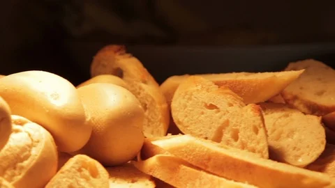 Stack of Plates and Lots of Bread Under Light Stock Footage 102518107