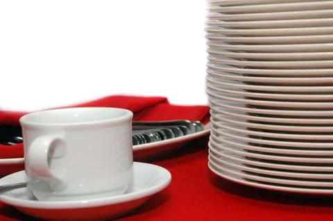 Stack of plates, cup and spoons Stock Photos