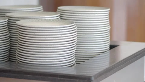 Stack of plates in a restaurant kitchen during lunch rush Stock Footage 339996510