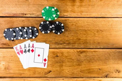 Stack of poker chips and aces on wooden background, poker chips spread, big b Photos