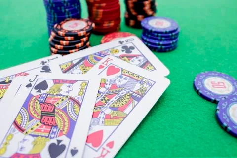 Stack of poker chips and cards on a green game table Stock Photos