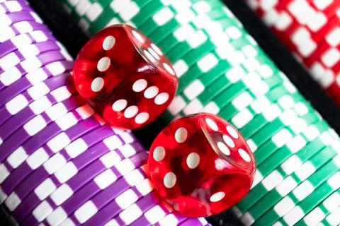 Stack of poker chips with dice rolls isolated background. Poker game concept. Stock Photos