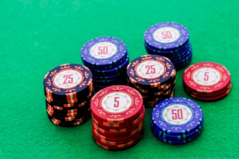 Stack of poker chips on green background Stock Photos