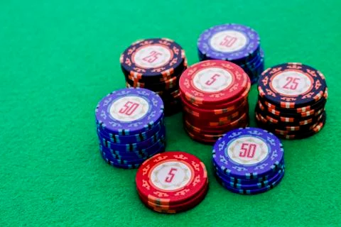 Stack of poker chips on green background Stock Photos