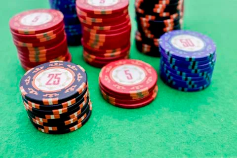 Stack of poker chips on a green game table Stock Photos