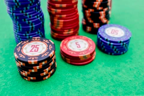 Stack of poker chips on a green game table Stock Photos