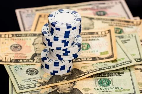 Stack of poker chips over american dollar bills and playing cards represent.. Foto stock