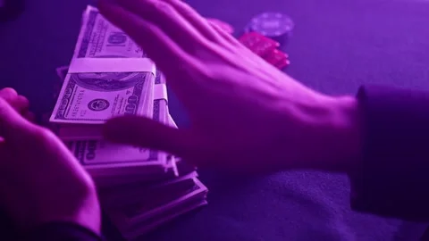Stack of poker chips in a range of colors and wad of dollars on the gaming .. Stock Footage 230242483