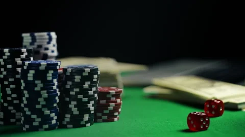 Stack of poker chips, red dice and money on green felt table, online casino play 動画素材 312329635