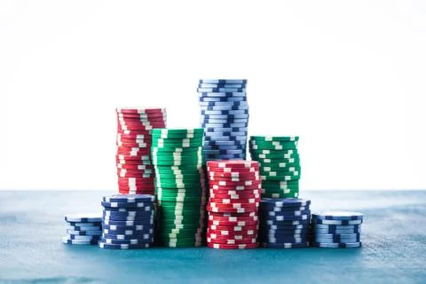 Stack of poker chips on the table on a white background isolate Stock Photos