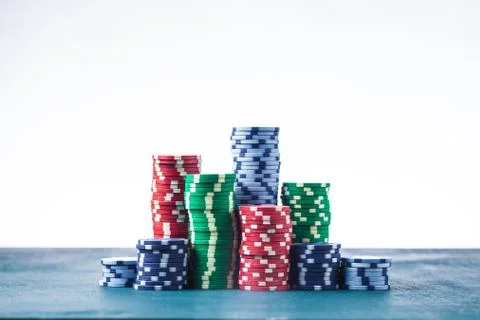 Stack of poker chips on the table on a white background isolate Stock Photos