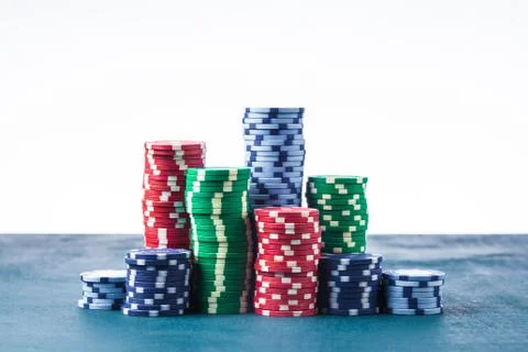 Stack of poker chips on the table on a white background isolate Stock Photos