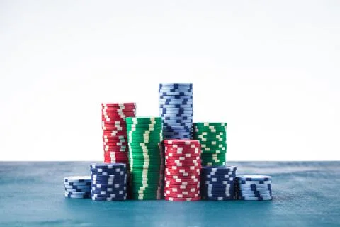 Stack of poker chips on the table on a white background isolate Stock Photos