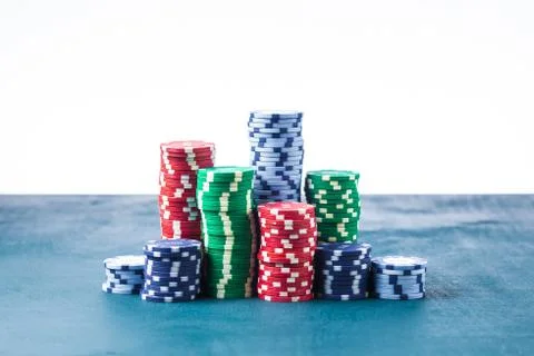 Stack of poker chips on the table on a white background isolate Stock Photos