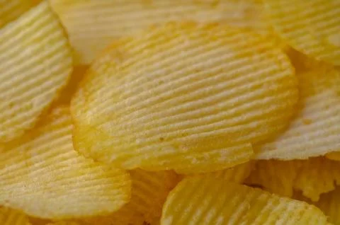 A stack of potato chips, a popular junk food, placed Stock Photos