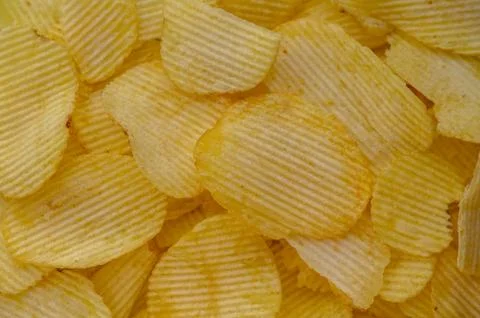 A stack of potato chips, a popular junk food, placed 1 Stock Photos