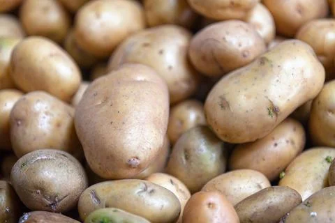 Stack of potatoes on a market stall Stock Photos