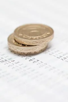 Stack of pound coins on financial data Stock Photos