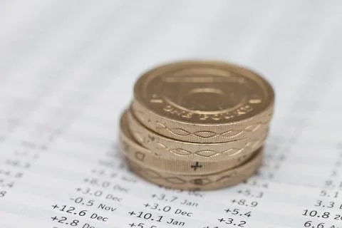 Stack of pound coins on financial data Stock Photos