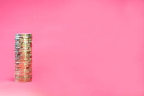 Stack Pound Coins on a Pink Background - Negative Space for Copy 写真素材