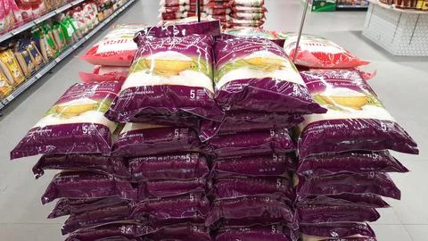 Stack of premium packed rice bag 5kg ready for sell in the supermarket Stock Photos