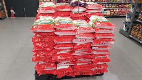 Stack of premium packed rice bag 5kg ready for sell in the supermarket Stock Photos