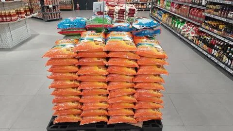 Stack of premium packed rice bag 5kg ready for sell in the supermarket Stock Photos