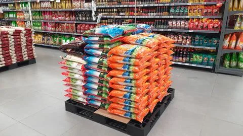 Stack of premium packed rice bag 5kg ready for sell in the supermarket Stock Photos