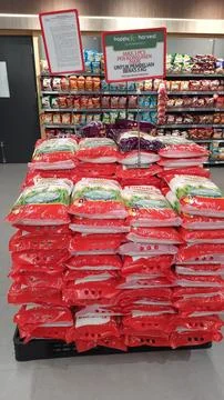 Stack of premium packed rice bag 5kg ready for sell in the supermarket Stock Photos